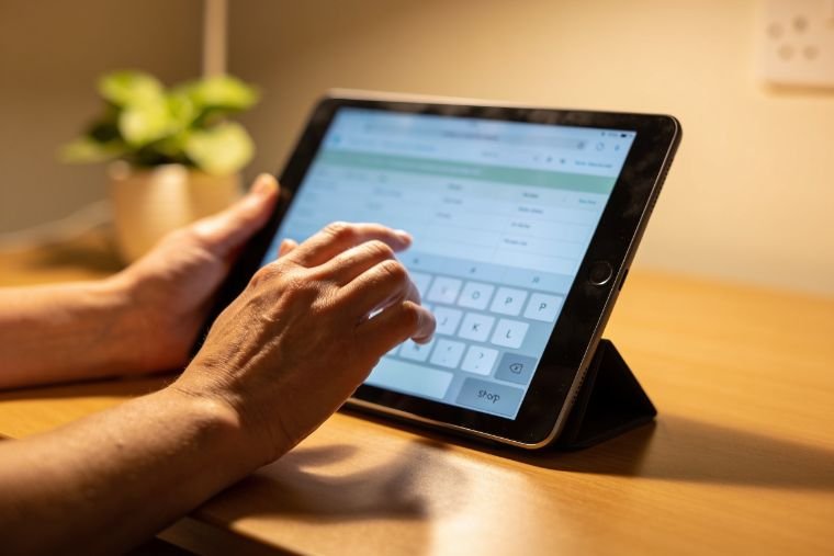 A Bristol care manager's hands posting an HCA shift on MAP HealthCare Connect