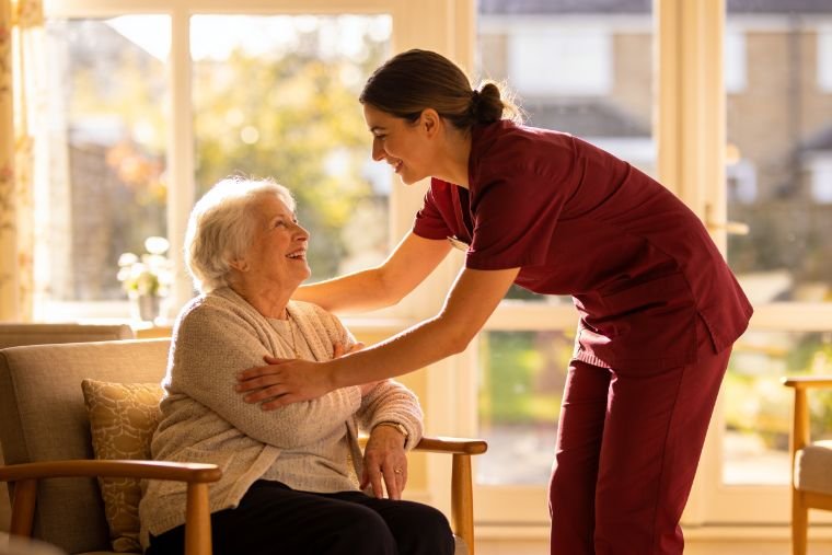A MAP HealthCare HCA warmly greeting an elderly Bristol care home resident through the rebook feature