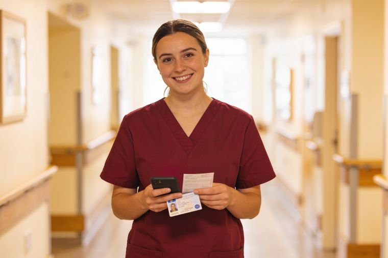A MAP HealthCare professional holding DBS and right-to-work documents for Bristol care home compliance
